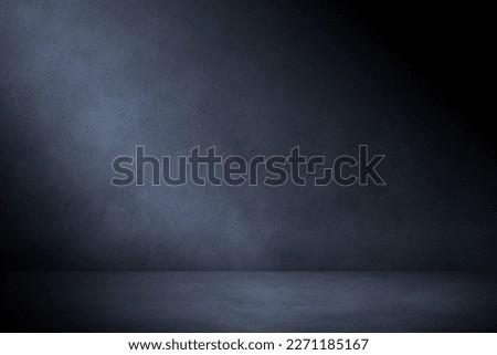 Concrete wall and floor in the dark with blue lighting. Urban concrete  background for mock up or design.
