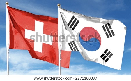South Korea and Switzerland flags against cloudy sky. waving in the sky