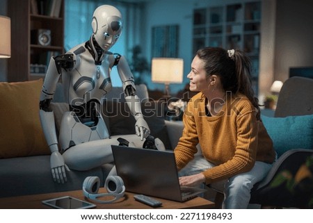 A pretty young girl studies with the help of her android equipped with artificial intelligence. Concept of usefulness of A.I. in people's daily lives.  Royalty-Free Stock Photo #2271198493