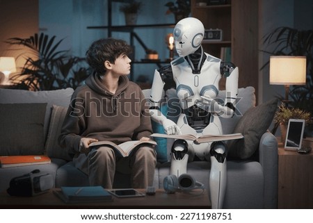 Innovative AI robot tutor helping a teenage boy with homework, they are reading books together, human-robot interaction concept Royalty-Free Stock Photo #2271198751
