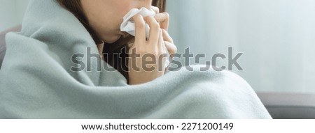Sick day at home. Asian woman has runny and common cold. Royalty-Free Stock Photo #2271200149