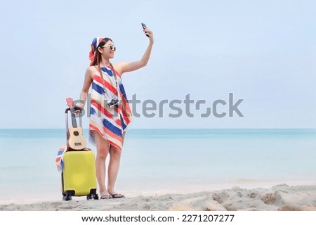 Women with luggage on the beach, Relax and chilling, summer holiday, Women with colorful outfit, Sunny day, Happy girl, Selfie with smile.
