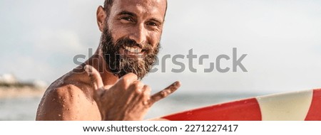 Horizontal banner or header with surfer happy with surf surfing smiling doing hawaiian Shaka Brah or Hang Loose during surf session in ocean waves on beach vacation - Greeting in surfer culture
