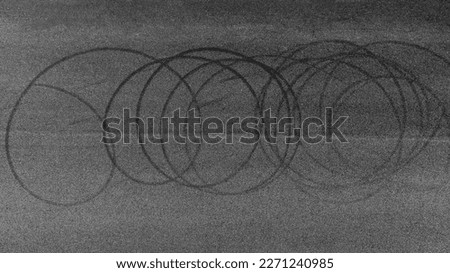 Aerial view tire track mark on asphalt tarmac road race track texture and background, Abstract background black tire track skid on asphalt road, Tire mark skid mark on asphalt road. Royalty-Free Stock Photo #2271240985