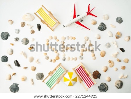 Beach composition on the seashore, bright sun lounger, yellow umbrella, tourist plane, seashells.  The concept of rest in warm countries, travel.  Flat lay, top view.