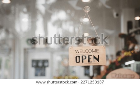 Open sign board through the door glass.