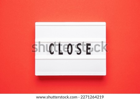 Lightbox with word close on red background