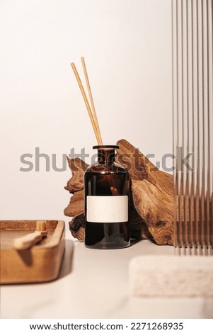 Scented home perfume reed diffuser with woody fragrance concept. Vertical photography. Royalty-Free Stock Photo #2271268935