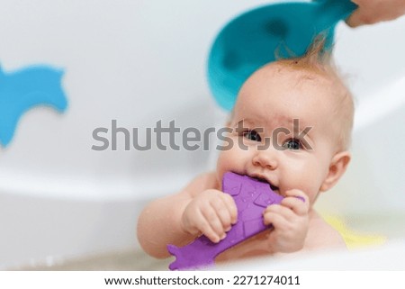 Cute Caucasian Baby takes a bath