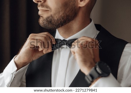 The stylish bridegroom dresses, prepares for the wedding ceremony. The groom's morning. Businessman wears a jacket, male hands closeup, groom getting ready in the morning before wedding ceremony Royalty-Free Stock Photo #2271279841