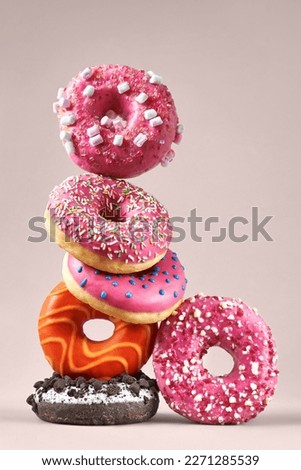 Creative composition of various donuts. Set of donuts with different color glaze. Donuts with chocolate, erysipelas icing, marshmallows and various flavorings. Royalty-Free Stock Photo #2271285539