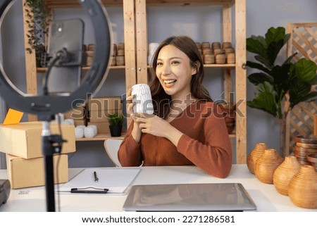 Asian Woman Blogger Sale Her Vase Online By Going Live Sell on Social Media on Her Mobile Phone Royalty-Free Stock Photo #2271286581