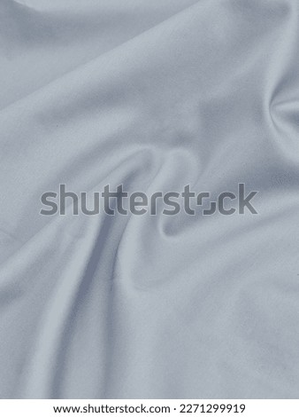 Smooth elegant grey silk or satin luxury cloth texture can use as abstract background. Luxurious background design
