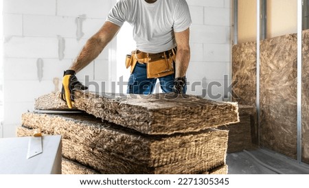 Placing acoustic insulation in a plasterboard konstruksion. Royalty-Free Stock Photo #2271305345