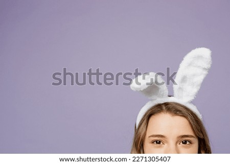 Cropped close up photo shot of young caucasian woman wear bunny rabbit ears loking camera isolated on plain pastel light purple violet color background studio portrait. Lifestyle Happy Easter concept