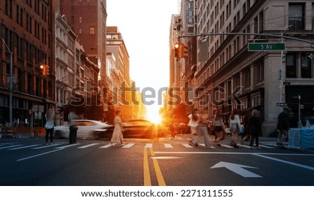 Sunlight shining on the people and cars at a busy intersection on 5th Avenue in Manhattan, New York City Royalty-Free Stock Photo #2271311555