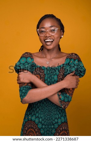 African woman smiling embrace equity on a yellow background