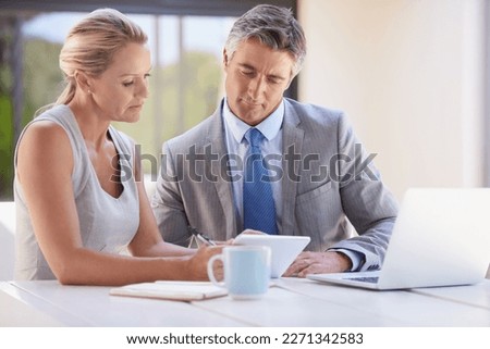 What do you think about this. two colleagues working together at a desk.