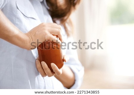 The lid is really tight. Cropped image of a woman trying to open a jar in the kitchen. Royalty-Free Stock Photo #2271343855