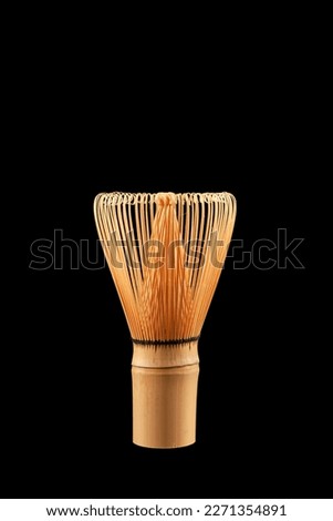 Chasen or Bamboo tea whisk on black background, close-up. Accessory for whipping Matcha tea. Royalty-Free Stock Photo #2271354891