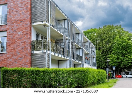 Red brick apartment building with balconies and balconies in Germany.