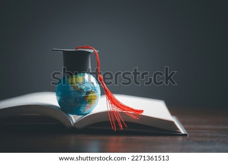 Graduation cap with Earth globe. Concept of global business study, abroad educational, Back to School. Education in Global world, Study abroad business in universities in worldwide. language study Royalty-Free Stock Photo #2271361513