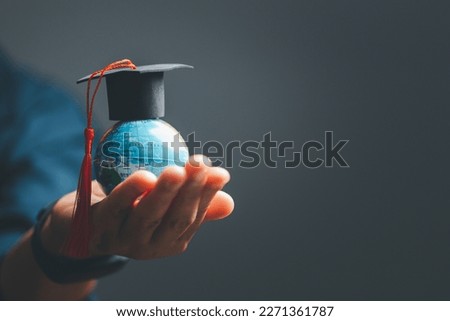 Graduation cap with Earth globe. Concept of global business study, abroad educational, Back to School. Education in Global world, Study abroad business in universities in worldwide. language study Royalty-Free Stock Photo #2271361787