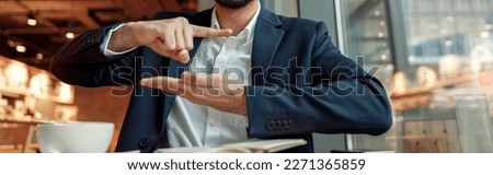 Businessman have a business meeting via video call and communicates using sign language in cafe