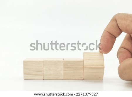 Businessman hand flipping wooden blank block cube on white background

