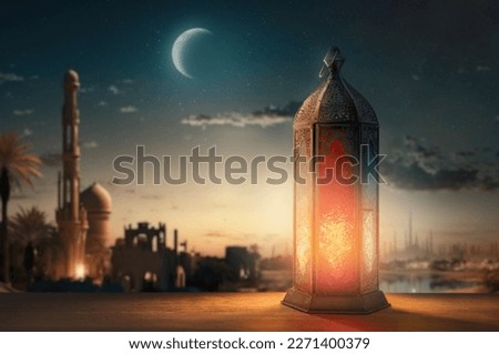 Ornamental Arabic lantern with burning candle glowing at night mosque background. Festive greeting card, invitation for Muslim holy month Ramadan Kareem. Royalty-Free Stock Photo #2271400379