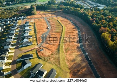 Real estate development with tightly located family houses under construction in South Carolina suburban area. Concept of growing american suburbs Royalty-Free Stock Photo #2271404463
