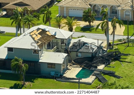 Hurricane Ian destroyed swimming pool lanai enclosure on house yard in Florida residential area. Natural disaster and its consequences Royalty-Free Stock Photo #2271404487