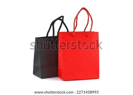 Black and red paper shopping bags isolated on white background. Gifts and shopping concept Royalty-Free Stock Photo #2271438993