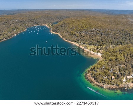 Aerial drone view of Currawong Beach and The Basin on the western shores of Pittwater in Ku-ring-gai Chase National Park, Sydney, NSW, Australia. Currawong can be reached via ferry from Palm Beach. Royalty-Free Stock Photo #2271459319
