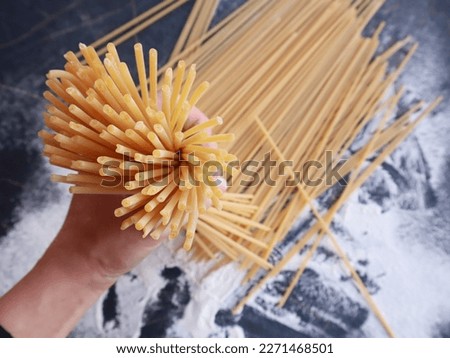 First person shoot of bucatini pasta. ingredients of typical italian cuisine. Royalty-Free Stock Photo #2271468501