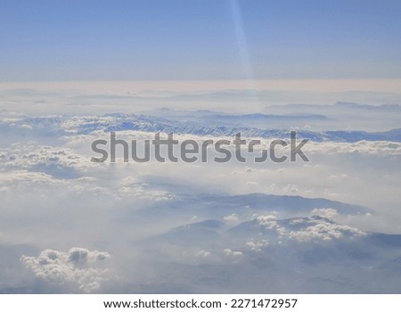 Clouds above the earth as a background. View from the airplane window.