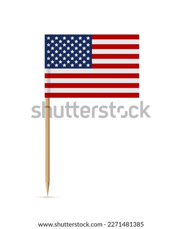 Miniature rectangle paper American flag on wooden stick or toothpick. Decoration for cupcake or other food. 4th of July, Independence or Presidents Day of USA, United States of America.