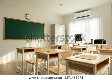 Shot of empty classroom with chairs under desks in elementary school. School during vacation or holidays, A teaching classroom without students during a term break or the end of semester in kindergart