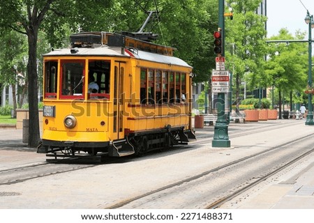 A yellow electric trolley on Main Street in downtown Memphis, Tennessee in summer Royalty-Free Stock Photo #2271488371