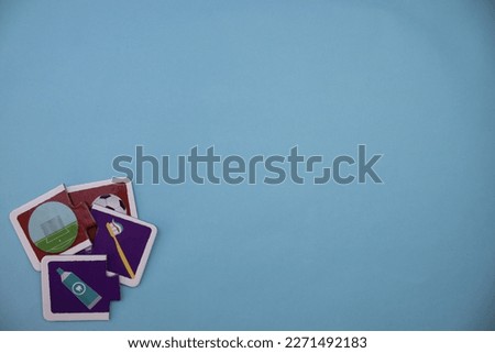 Educational puzzle pieces with pictures of soccer ball, soccer goal, toothbrush and toothpaste placed at lower left on blue background.