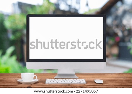 Computer Monitor, Keyboard, coffee cup and Mouse with Blank or White Screen Isolated is on the work table with workspace. 