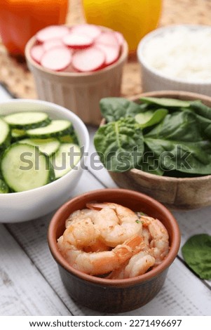 Ingredients for poke bowl on white wooden table