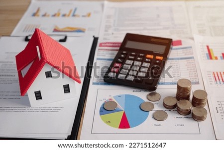 Property tax.investment planning.business real estate. View Of coin stack with house model, mortgage loading real estate property with loan money bank concept.Home sales and home insurance concept.