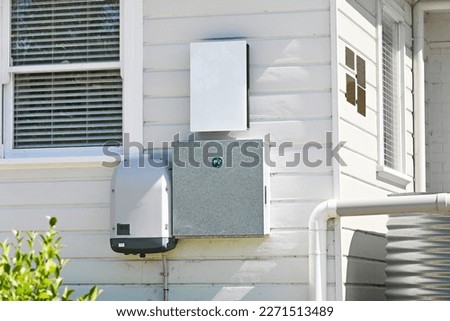 Solar inverter and meter box on the side of a house Royalty-Free Stock Photo #2271513489