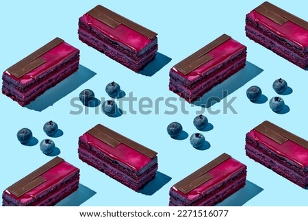 Blueberry sponge cake with a composition with berries on a blue background. Food pattern