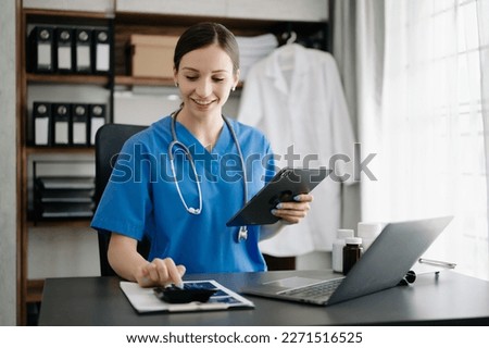 Healthcare costs and fees concept.Hand of smart doctor used a calculator and smartphone, tablet for medical costs at hospital 

