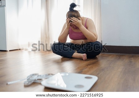 Obese Woman with fat upset about her belly. Overweight woman touching his fat belly and want to lose weight. Fat woman worried about weight diet lifestyle. Royalty-Free Stock Photo #2271516925