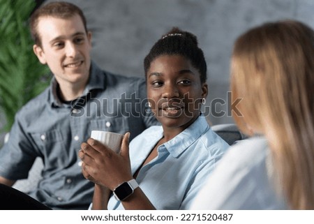Multiracial coworkers having casual chatt. Black woman talking to friends. Royalty-Free Stock Photo #2271520487