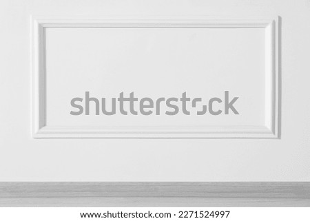 Beautiful white wall with molding in clean empty room
