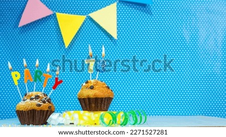 Festive muffin pie with candles for a birthday. Birthday background with numbers  78. Anniversary card on blue polka dot background, copy space